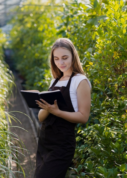 Free photo greenhouse worker with agenda