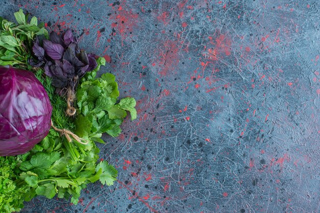 Greens and purple cabbage, on the marble background. 