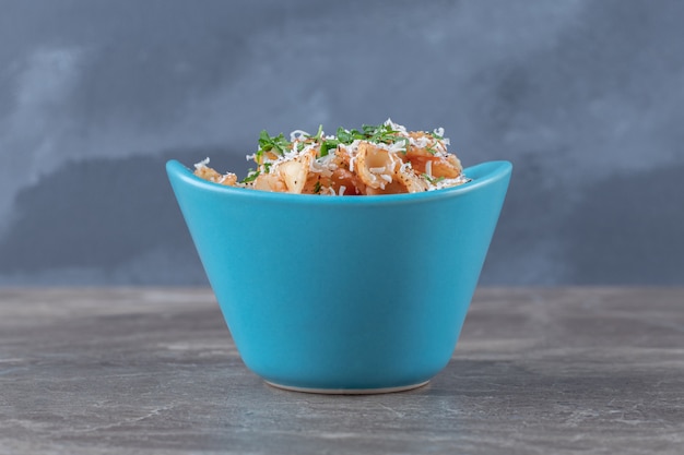 Greens vegetable with farfalle pasta in the bowl , on the marble surface.