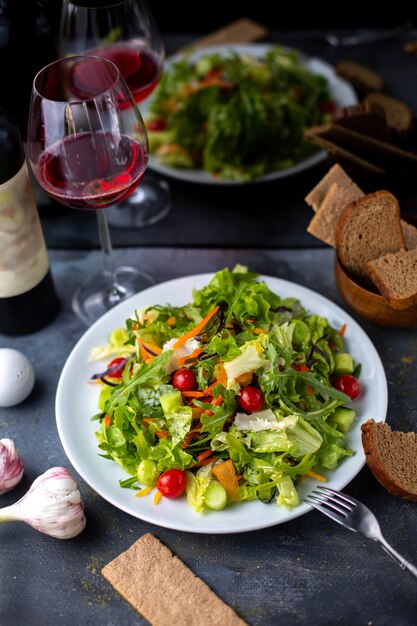 greens vegetables sliced along with red wine inside white plate