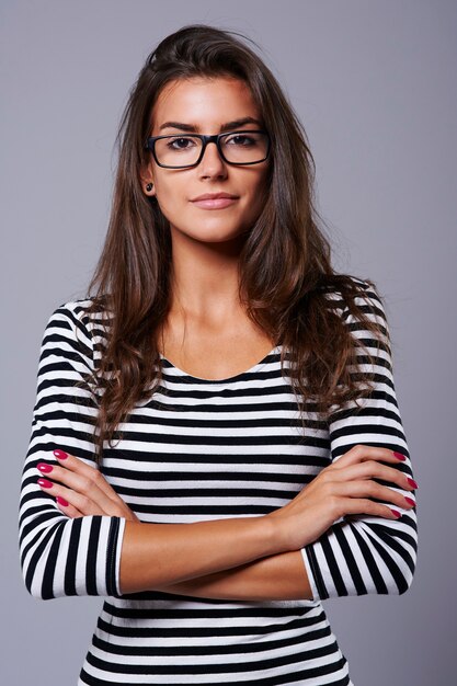 Grey background and woman with black glasses