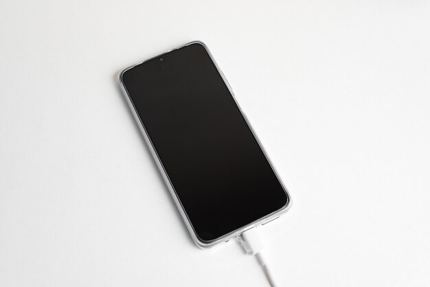 Grey cell phone connected to USB cable type C - Charging
