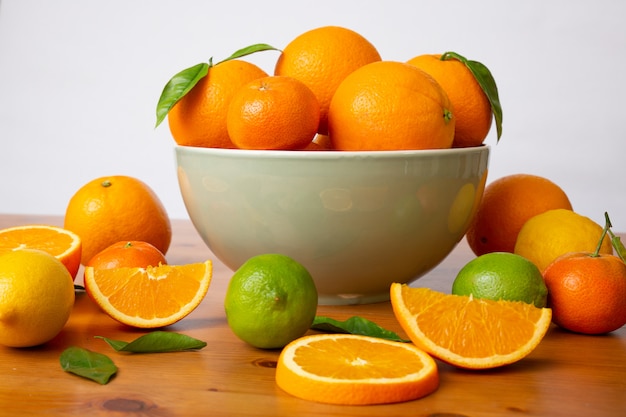 Grey ceramic bowl with fresh citrus fruits