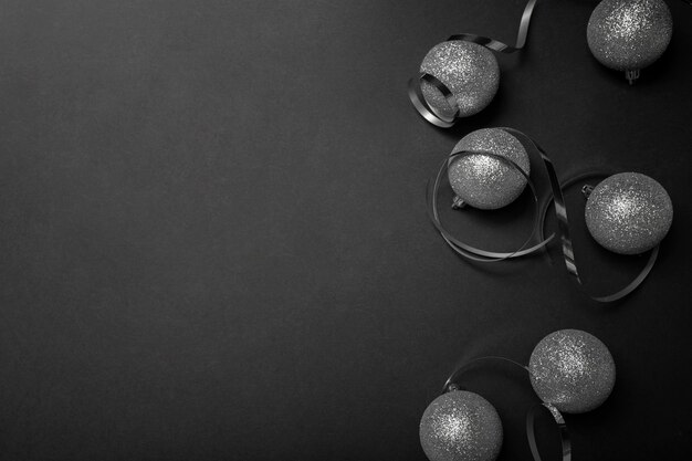 Grey Christmas ornaments on black table