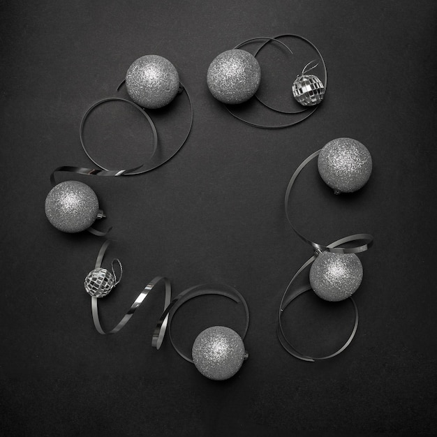 Grey Christmas ornaments on black table