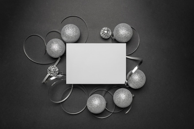 Grey Christmas ornaments on black table