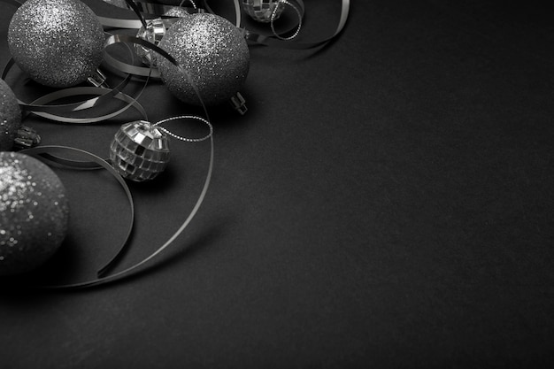 Free photo grey christmas ornaments on black table