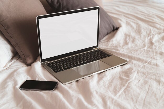 Grey laptop on the bed