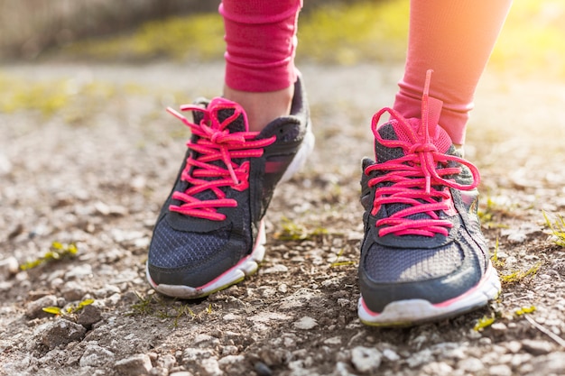 Grey and pink sneakers on the ground