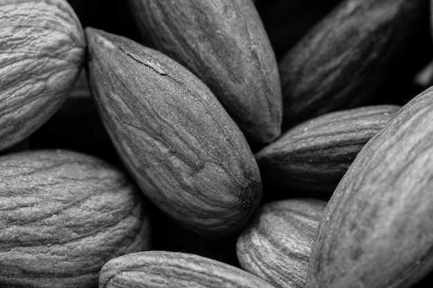 Greyscale closeup shot of a lot of almonds