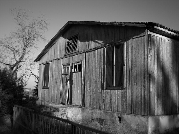 Greyscale of an old wooden barn under the sunlight at daytime