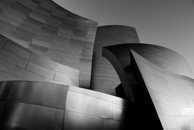 Greyscale shot of the facade of a modern building with dark grey walls