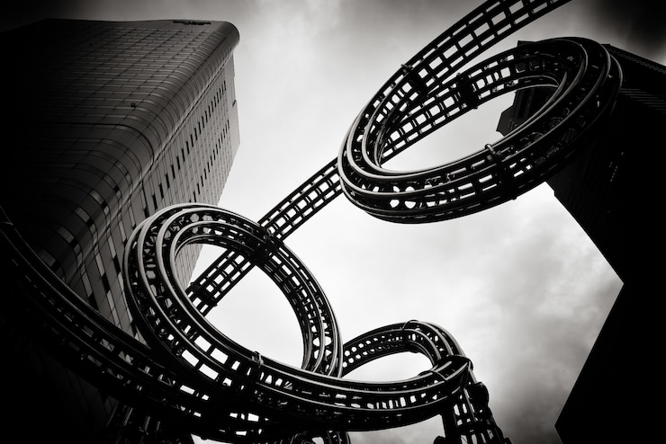 Free Photo greyscale shot of a high rise building next to an object designed to look like a film tape