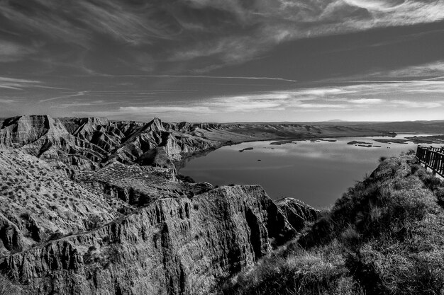 Greyscale shot of the mountains near the lake in Burujon, Spain