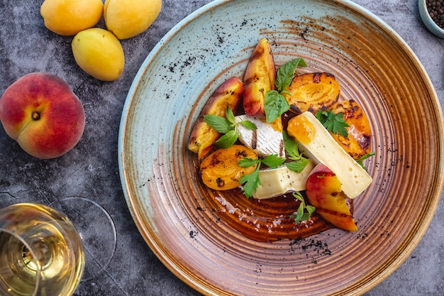 Grilled apricot and peach served with cheese and mint