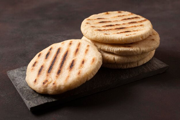 Grilled arepas on wooden board