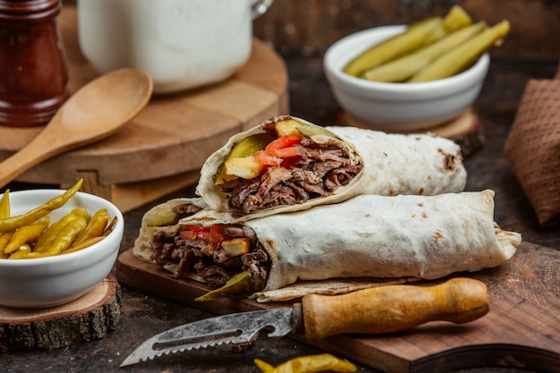 grilled beed wrap doner with cucumber prinkles, tomato and fries