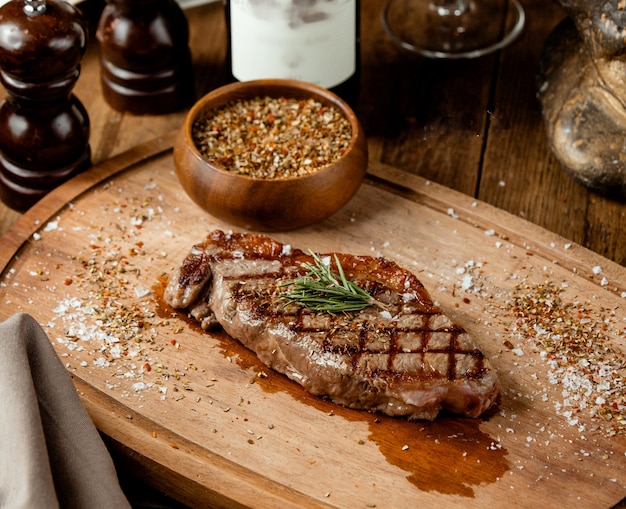 Grilled beef steak garnished with dried herbs and salt