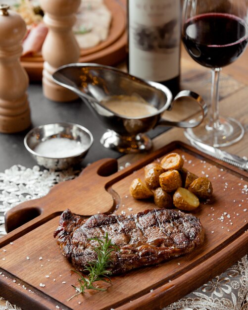 Grilled beef steak served with roasted baby potatoes