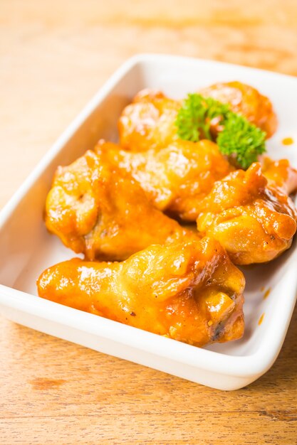 Grilled buffalo wings in white plate