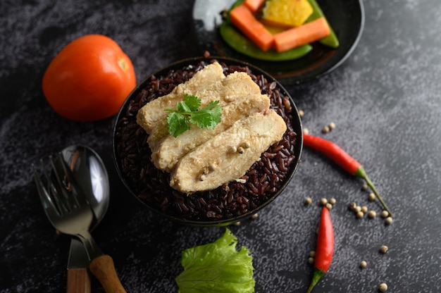 Grilled chicken breast topped with pepper on ripe purple rice berries.