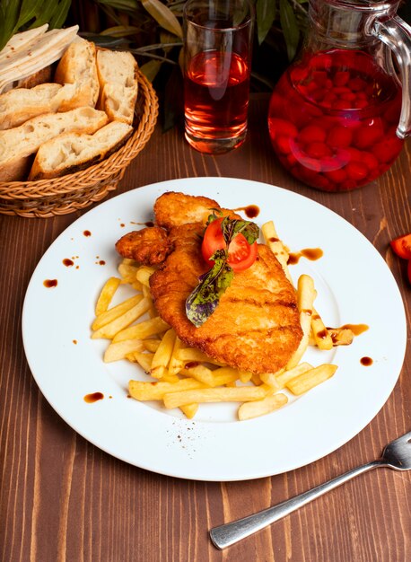 Grilled chicken breast with french fries in white plate. fast food