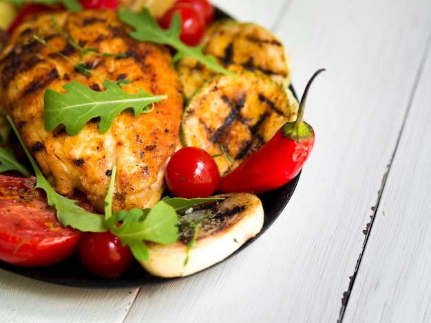 Grilled chicken breasts with vegetables