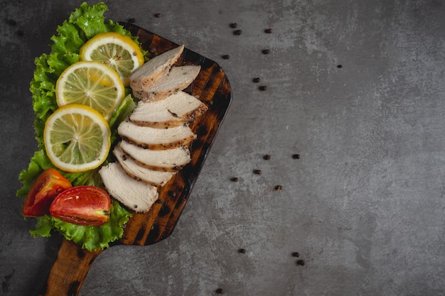 Grilled chicken on a cutting board.