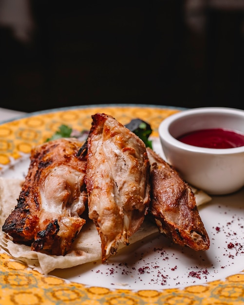 Free photo grilled chicken on lavash parsley basil onion sumakh sour sauce side view