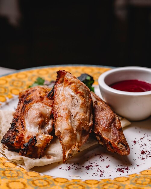 Grilled chicken on lavash parsley basil onion sumakh sour sauce side view