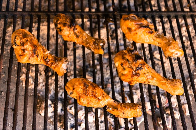 Grilled chicken legs on hot grill 