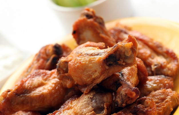 Grilled chicken wings on a white table 