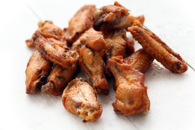 Free photo grilled chicken wings on a white table