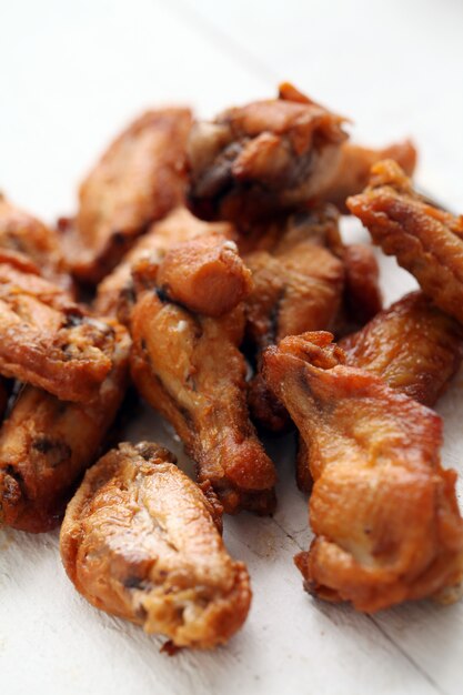 Grilled chicken wings on a white table 