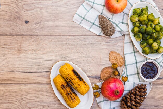 Grilled corns with brussels sprouts on table 