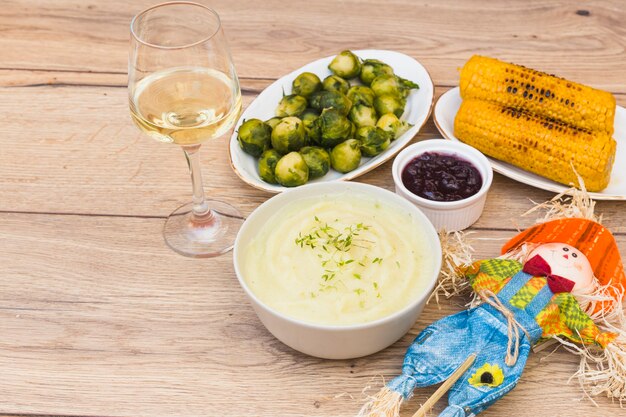 Grilled corns with glass of wine on table