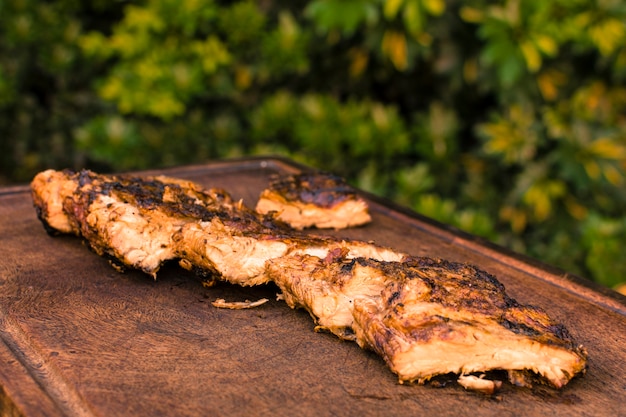 Grilled meat placed on table 