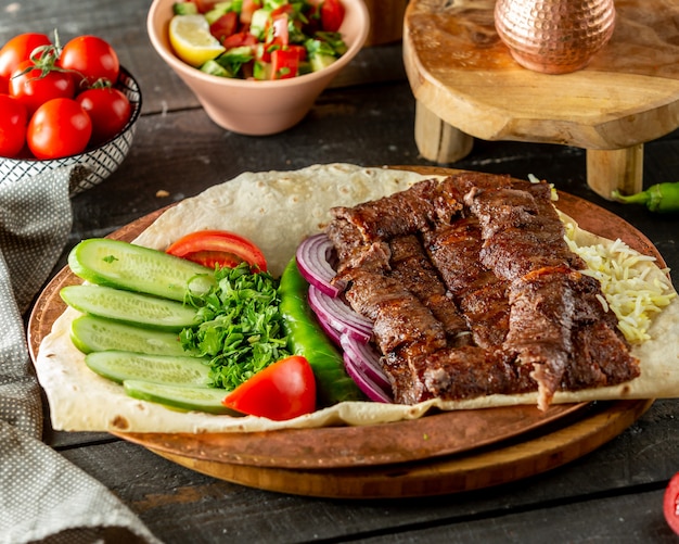 Grilled meat served with fresh vegetables