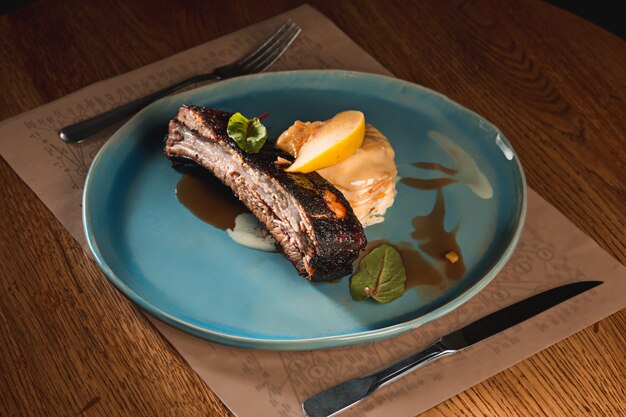 Grilled pork ribs on dark plate