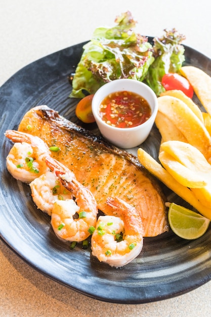 Grilled salmon and prawn steak