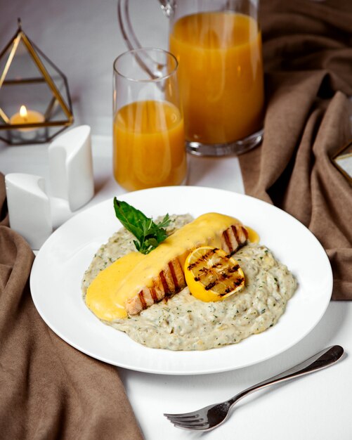 Grilled salmon topped with melted cheese, served with risotto