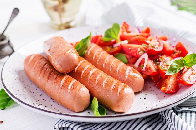 Grilled sausage with tomatoes, basil and red onions