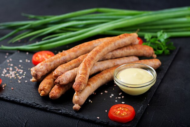 Grilled sausages on dark background. Oktoberfest.