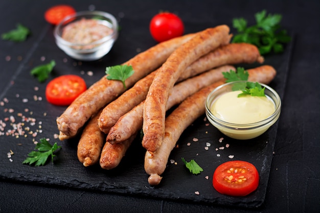 Grilled sausages on dark background. Oktoberfest.