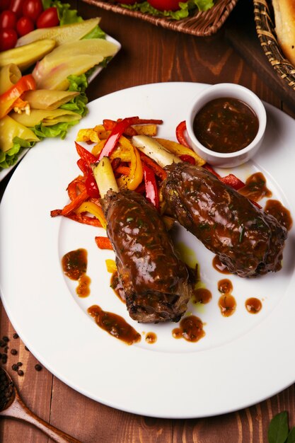 Grilled with teriyaki sauce beef lamb with grilled bell pepper in white plate. 