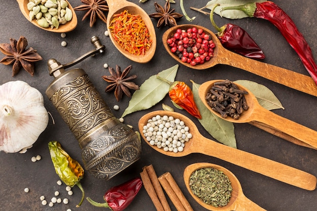 Grinder and wooden spoon with spices