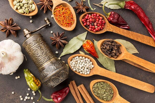 Grinder and wooden spoon with spices