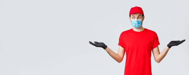 Groceries and packages delivery covid quarantine and shopping concept surprised courier in red cap a...