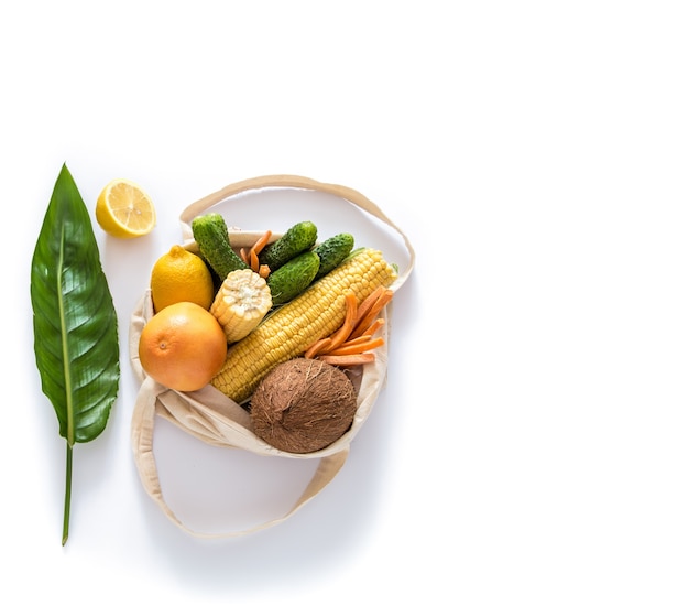 Grocery shopping with eco bag over white wall. Zero waste and plastic free concept. Flat lay. Copy space.