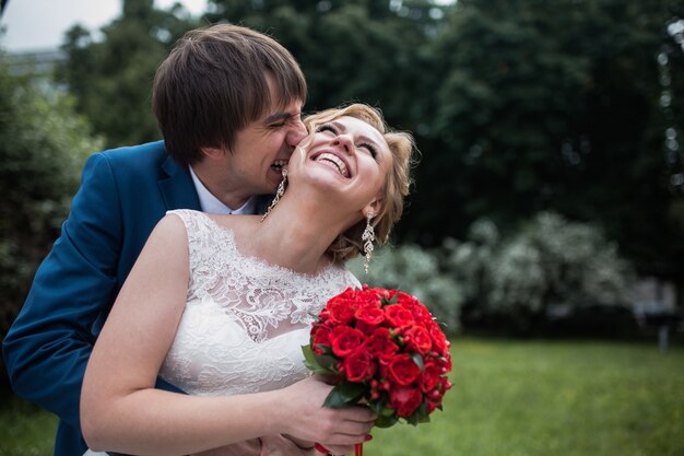 Groom biting his wife's ear